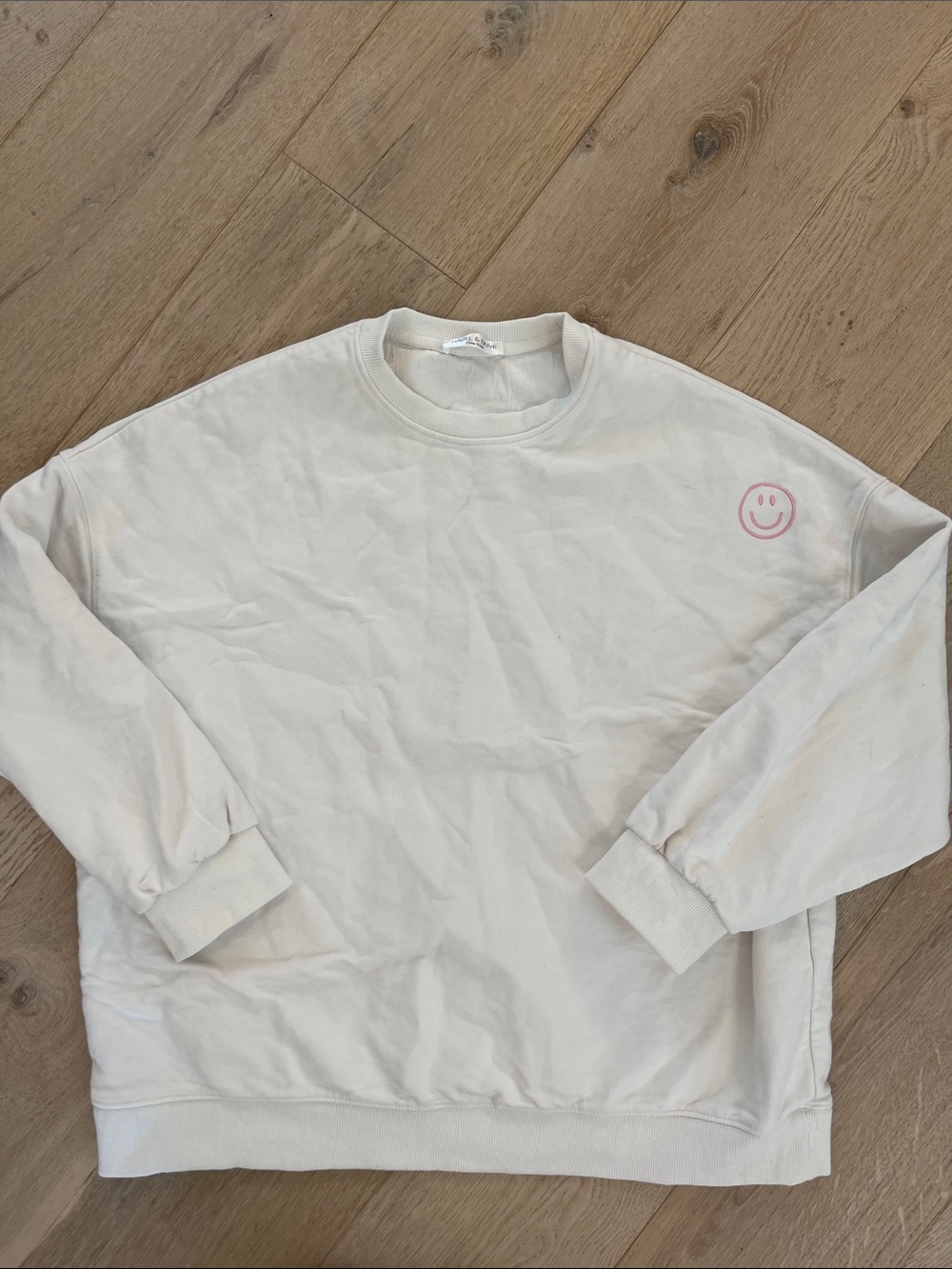 HAZEL & OLIVE womens white sweatshirt with pink smiley face embroidered logo